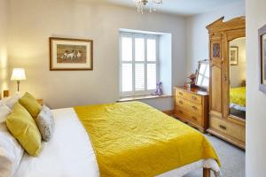 a bedroom with a bed and a dresser and a window at North England - North Pennines AONB in Westgate