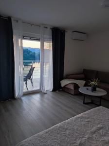 a bedroom with a bed and a couch and a table at Lago d'argento sobe in Veliko Gradište