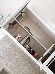 a small refrigerator with its door open in a kitchen at La Casa de Mamá in San Fernando de Monte Cristi