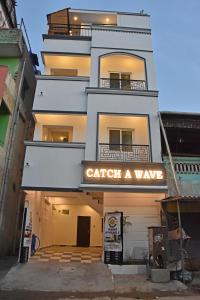 a building with a sign that reads catch a wave at Catch A Wave in Mahabalipuram