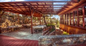 a restaurant with tables and chairs on a patio at Kallisti Hotel in Potos