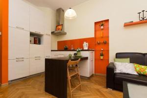 a kitchen with a couch and a table in a room at Urban Nest Apartments Dietla 69-8B in Kraków