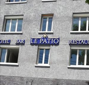 a building with a sign on the side of it at LE PATIO in Millau