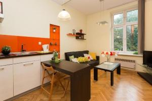 a kitchen and living room with a table and a couch at Urban Nest Apartments Dietla 69-8B in Krakow