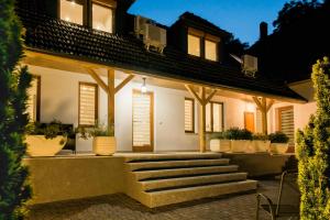 a house with stairs in front of it at Diófa Apartman in Keszthely