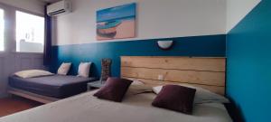 a bedroom with a large bed and a couch at Cactus Anse Des Rochers in Saint-François