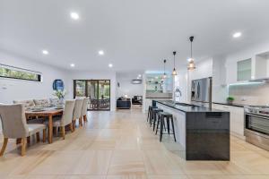 a kitchen and dining room with a table and chairs at Airlie Beach Home in Airlie Beach