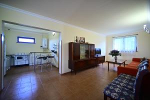 a living room with a couch and a kitchen at Sevan Tarsus Guesthouse in Tsovazard