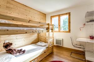 a room with two bunk beds and a window at Apartment Chalet des Granges in Les Houches