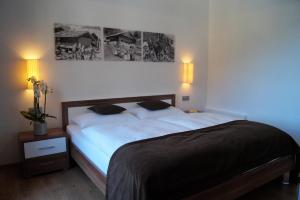 a bedroom with a large bed with two pillows at Haus Maiern in Ridanna