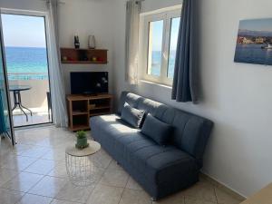 a living room with a couch and a view of the ocean at Julies Studios in Chania Town