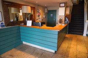 a restaurant with a blue counter and stairs at The Royal Hotel in Whitley Bay