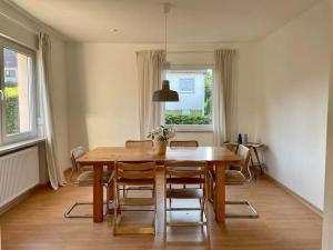 a dining room with a wooden table and chairs at Villa Rosa in Bad Sachsa
