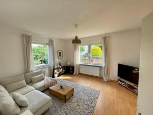 a living room with a couch and a coffee table at Villa Rosa in Bad Sachsa