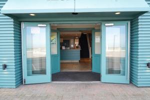 an open door of a blue building at The Royal Hotel in Whitley Bay