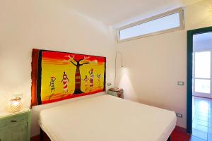 En eller flere senge i et værelse på Bilocale Sant'Anna Vicolo del Mughetto 5 - Goelba + 17 billeder