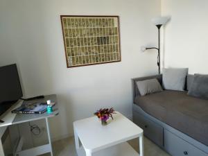 a small living room with a couch and a table at Ty cocooning in Kerlouan