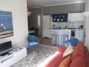 a living room with a couch and a kitchen at La Felice Casa Di Nonno Battistino in Apricale