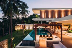 an exterior view of a house with a swimming pool at Anaia in Thong Sala