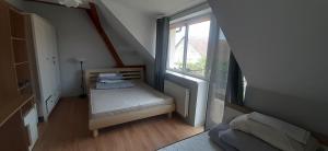 a small bedroom with a bed and a window at Mazurskie Wzgórze Dom Wakacyjny in Rydzewo +34 photos