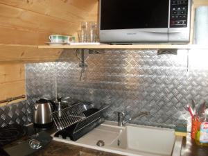 a kitchen with a sink and a microwave at Pokoje ,,Goramiba''Jurgów in Jurgów +153 photos