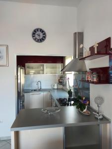 a kitchen with a counter and a stove top oven at LARA & VITO in Metajna