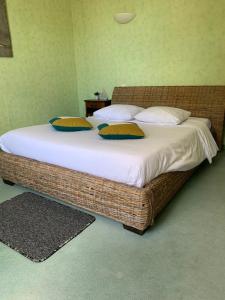 a bed with two pillows on it in a room at Le Richelieu in Saint-Jean-de-Monts