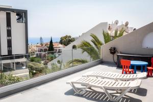 a balcony with two chairs and a table on a building at Bayview Terraces in Limassol