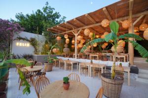 a restaurant with tables and chairs and lights at Faros Bodrum Hotel - Special Category in Golturkbuku