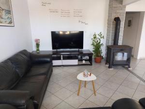 a living room with a couch and a tv and a table at LARA & VITO in Metajna