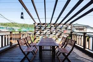 a wooden table and chairs on a balcony at Free Parking VAMOS A VER御宿 #RK1 in Iwada