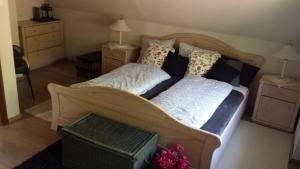 a bedroom with a wooden bed with two pillows at Chalúpka pod Lipkami in Kremnica