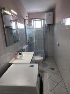 a bathroom with a sink and a toilet at LARA & VITO in Metajna