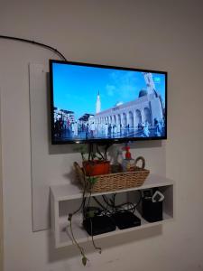 a flat screen tv hanging on a wall at Studio 7 - Hospital Italiano in Buenos Aires