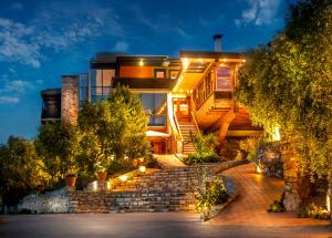 a house with a staircase leading up to it at night at Kallisti Hotel in Potos