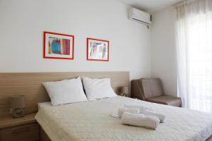 a bedroom with a bed with two towels on it at House Star in Petrovac na Moru
