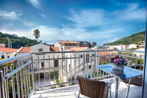 a balcony with a table and chairs and a view at House Star in Petrovac na Moru