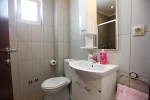a small bathroom with a toilet and a sink at House Star in Petrovac na Moru