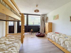 里蒙紐耶的住宿－Appartement Les Menuires, 2 pièces, 6 personnes - FR-1-344-369，一间卧室设有两张双层床和一扇窗户。