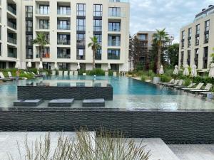 a large swimming pool with chairs and buildings at Studio PAMI in St. St. Constantine and Helena