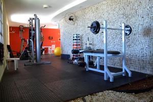 a gym with two treadmills and weights at Visual Praia Hotel in Natal