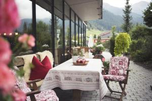 a table and two chairs on a patio at Skihotel Galzig B&B in Sankt Anton am Arlberg