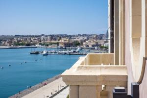 a view of a harbor from a building at Grand Hotel Des Etrangers in Siracusa