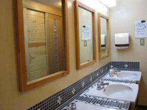 a bathroom with two sinks and two mirrors at Nozawa Onsen Utopia in Nozawa Onsen +59 photos