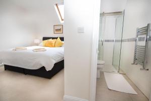 a bedroom with a bed and a glass shower at Morningside in Bonar Bridge