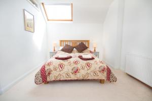 a bedroom with a bed in a white room at Morningside in Bonar Bridge