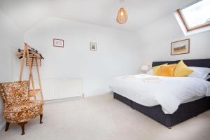 a bedroom with a bed and a chair at Morningside in Bonar Bridge