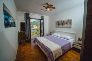 a bedroom with a large bed and a window at Seaside Apartments in Seget Vranjica