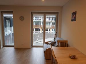 a living room with a table and a large window at White Forest in Juodkrantė