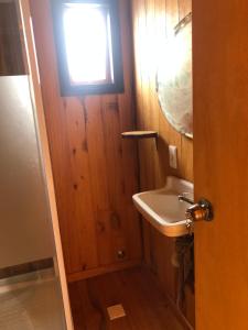 a small bathroom with a sink and a window at El nirvana in Aguas Dulces +2 photos